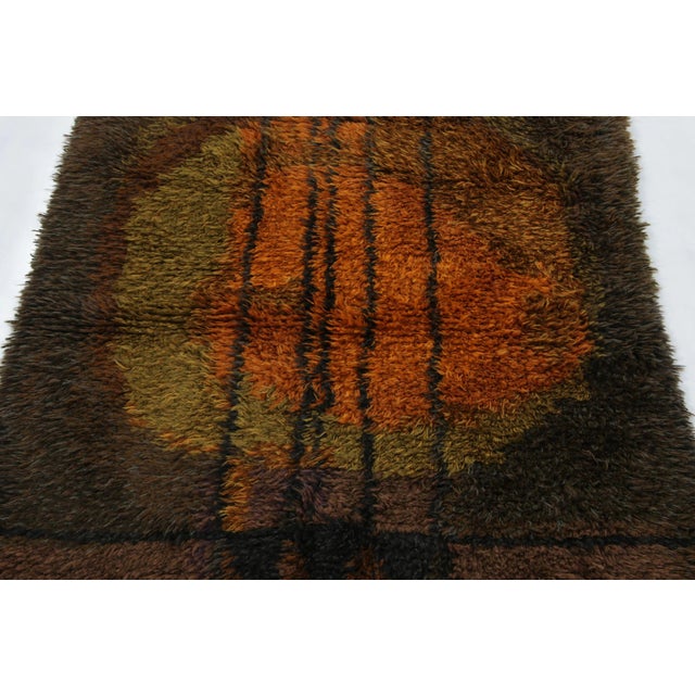Hand-knotted in lush, high-pile wool in Sweden circa 1960-1970, this 4x5 vintage Swedish Rya rug is a bold new addition to...