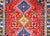 A bold and playful mid-20th century Persian Yallameh rug with three large central diamond medallions surrounded by...