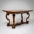 Walnut dining table with inlaid strapwork and an inlaid figural scene on the top. The legs are curved in a volute shape...