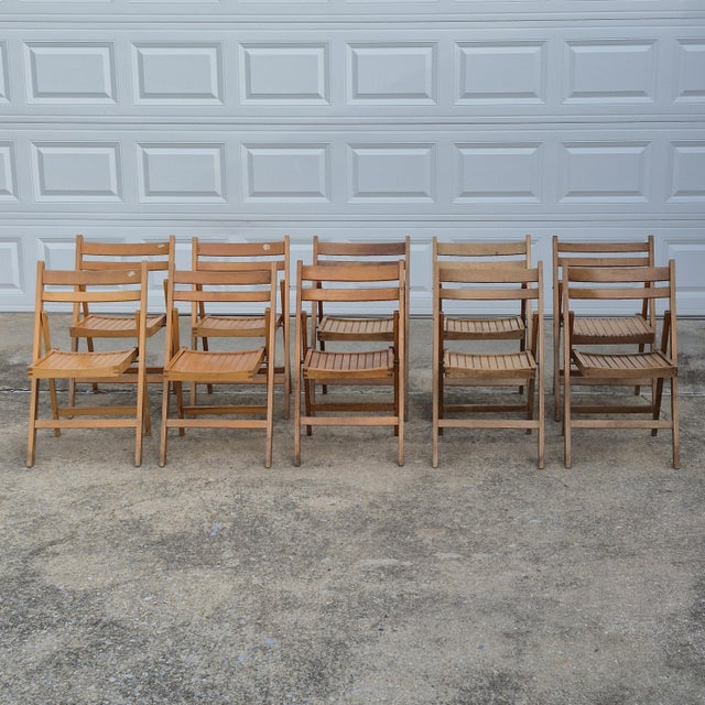 This is an assembled set of 10 vintage wooden folding chairs with slatted seats. Stamped Made in Romania or Made in...