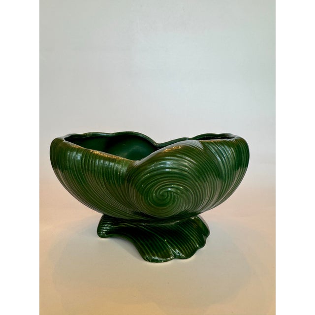 A swirl pattern adorns this abstract shaped low profile decorative ceramic bowl. It’s ridged texture and forest green...
