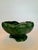 A swirl pattern adorns this abstract shaped low profile decorative ceramic bowl. It’s ridged texture and forest green...