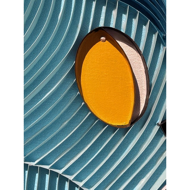 This mixed media artwork features a vibrant composition of paper strips, fabric, and acrylic, creating a playful yet...