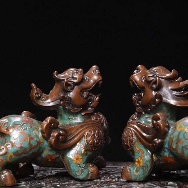 A striking pair of Chinese Cloisonné enamel Pixiu figures. These mythical creatures, traditionally believed to attract...
