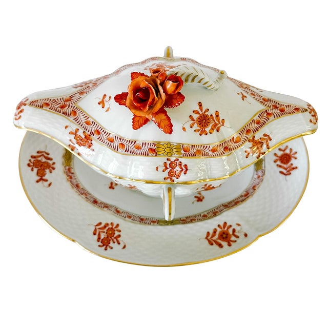 An exceptionally rare piece of Hungarian fine porcelain, this vintage Herend covered sauce boat with an attached...