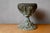 A decorative piece with a chalice look, this old metal planter was once the support for an oil lamp. Decorative and nicely...