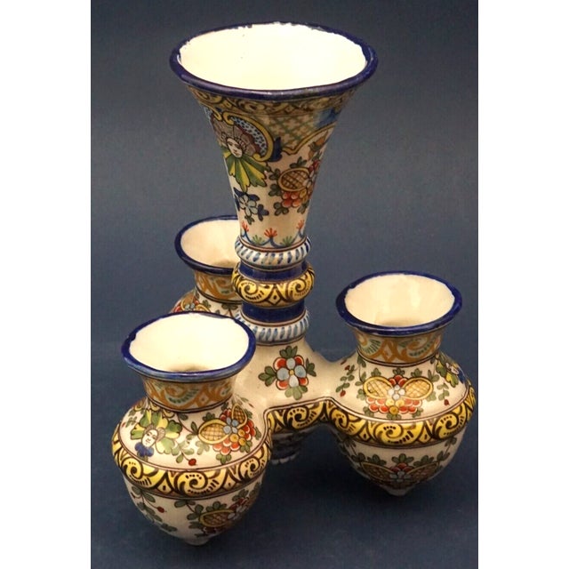 Spectacular glazed ceramic multiple vase, entirely hand-decorated. It consists of a larger central vase connected to four...