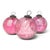 Three oversized cranberry glass ornaments create a luminous holiday grouping, each sphere carrying its own delicate...