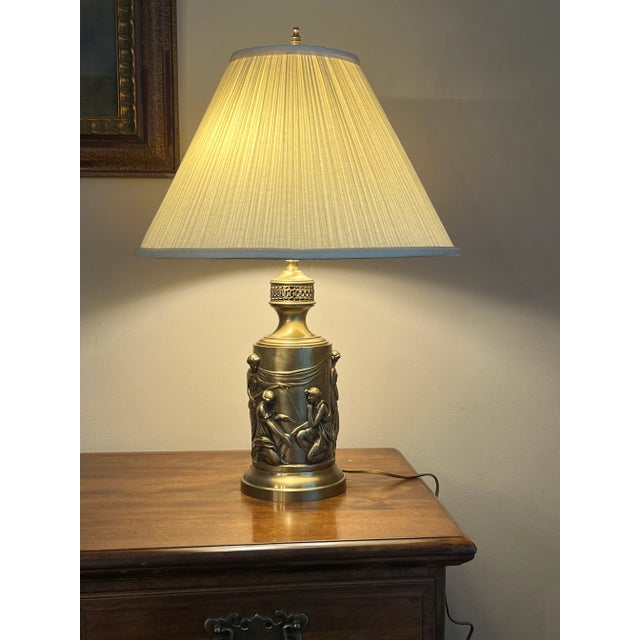 Hollywood Regency bas-relief metal base lamp with a Greek mythological figure of Arachne, the weaver motif, with shade....