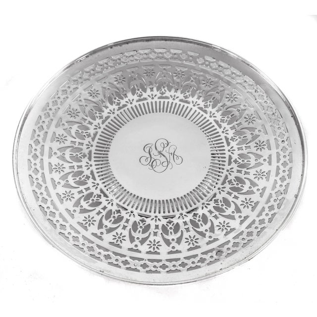 Look at the beautiful pierced work on these sterling plate; truly exceptional. It stands on a pedestal, raising it off the...