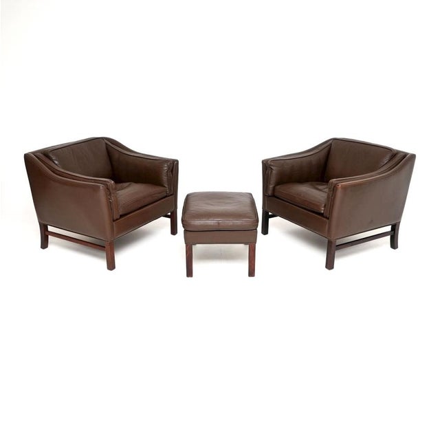 A stylish and extremely comfortable pair of Danish vintage leather armchairs with stool by Georg Thams for Grant...