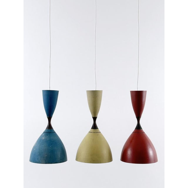 Set of three extremely rare, lovely and highly decorative mid-century modern diabolo pendant lamps or hanging lights....