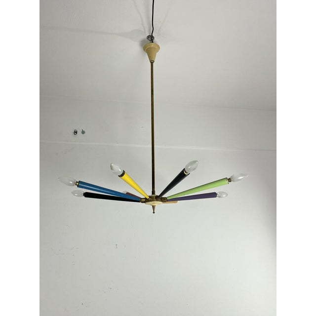 Mid-Century Sputnik 8-arm brass and colored enamel chandelier, in the style of Arredoluce, 1950s The arms are adjustable...