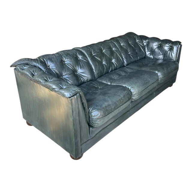 This elegant vintage leather sofa embodies the timeless sophistication of classic English Club design. Upholstered in rich...