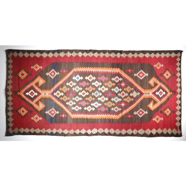 Antique Caucasian Karabagh Kilim with Bold Tribal Medallion in Crimson & Red Tones This powerful antique Caucasian...