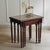 Three-piece mahogany nesting table set in the English Regency style, crafted in the second half of the 20th century. The...
