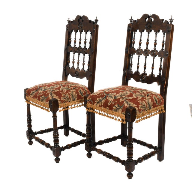 This Antique Pair of French Walnut Spindle Country Chairs brings a rustic aristocracy to any room. With hand-carved...