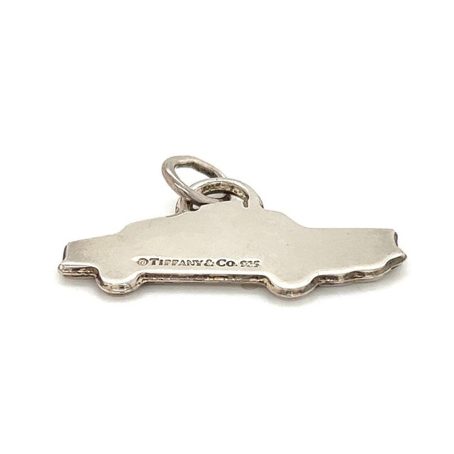 The Tiffany & Co. Sterling Silver Taxi Charm Pendant is a vintage piece of fine jewelry signed by the iconic brand....