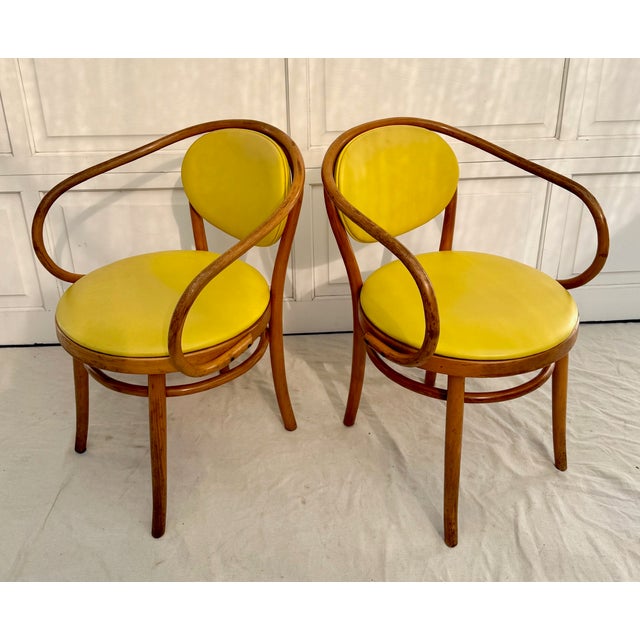 Here is a vibrant pair of Thonet bentwood armchairs from the 1970's. These iconic wraparound chairs feature Thonet’s...