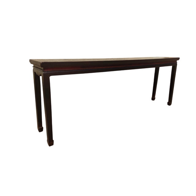 This 19th century console table is made from solid elm wood and features a simple, clean edge over a plain recessed apron....