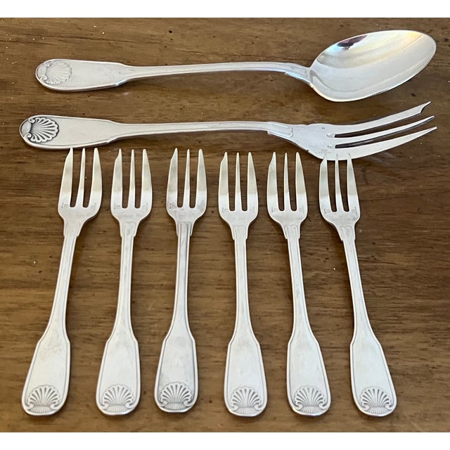 Christofle dessert serving flatware set made in France in the 1980's. The pattern called "Vendome" has a shell at the...