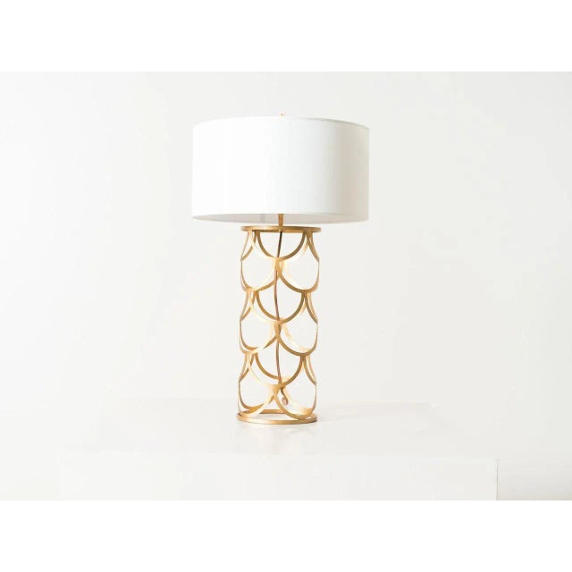 This is a gilded iron barrel lamp with a silk shade. The piece was contemporarily made.