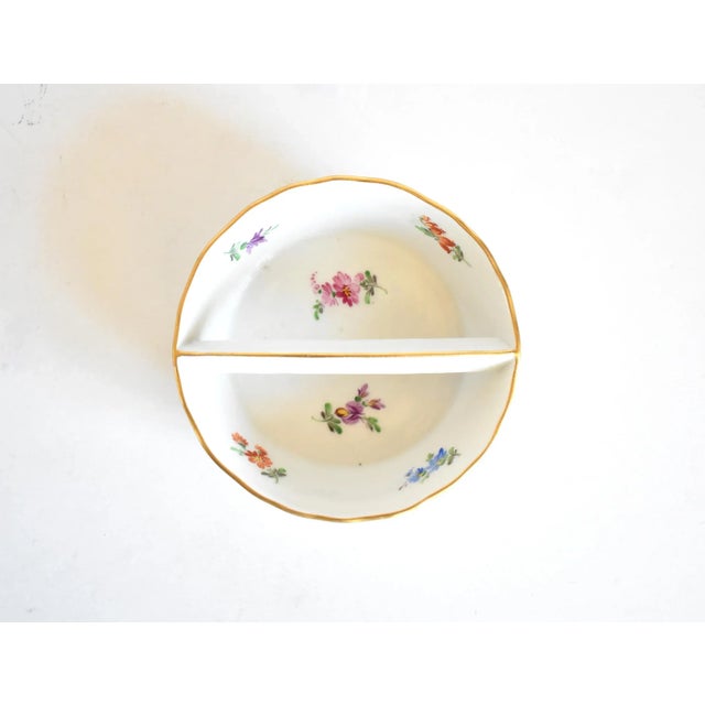 An antique, early 20th-century Meissen porcelain bowl in the "Scattered Flowers" pattern with flower sprigs strewn...