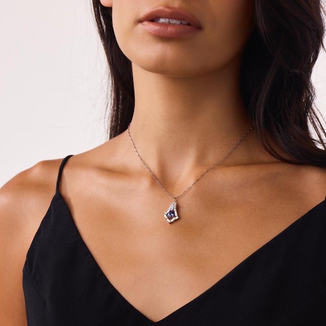 This elegant vintage tanzanite and diamond pendant necklace is a timeless design from the 2000’s, centered by a pear cut...