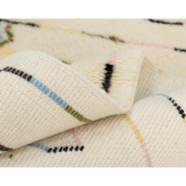 Beautiful Hand-knotted runner in a calming Natural Wool, adorned with delicate touches of Sky Blue, Midnight Black, Sage...