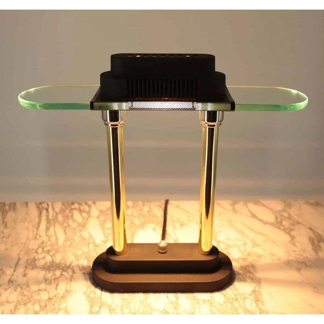 Designer lamp made of glass and polished brass on a black base. The lamp is dimmable for one smaller halogen bulb R7s up...