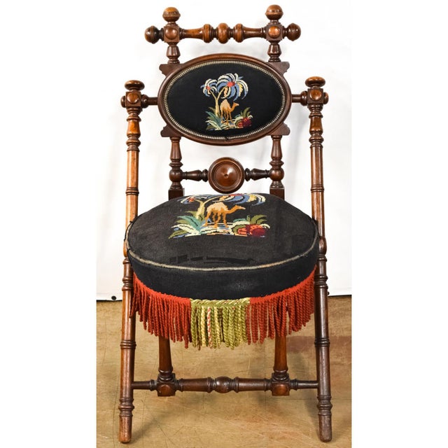 Antique Hunzinger mahogany side chair features black needlepoint upholstery with camel detail. Chair is signed and dated,...