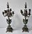 A Pair of 20th Century Empire Style Patinated and Green Marble Urn Form Seven-Light Candelabra. Each candelabrum has seven...