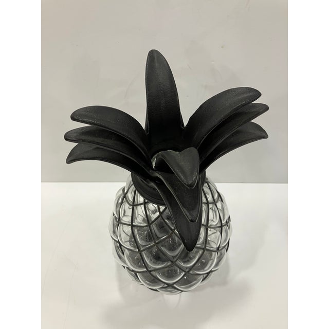 The glass was hand blown into the wire frame The base and the top leaves are iron All the glass is in perfect condition