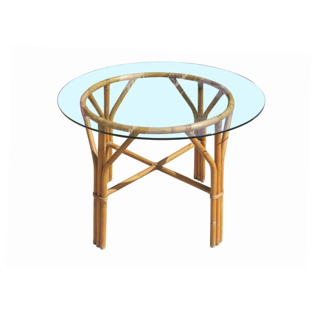 Mid-century rattan dining set featuring four dining chairs and dining table. This minimal, yet elegant dining table and...