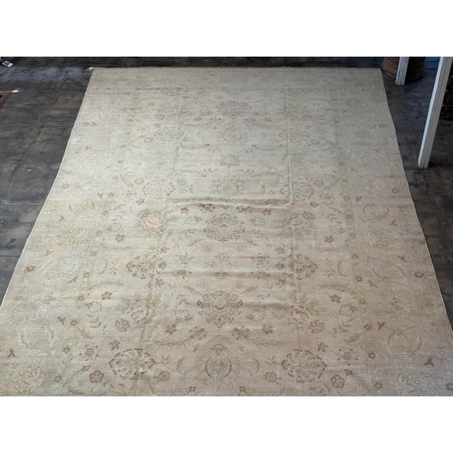 A refined Persian Mahal rug featuring an elegant allover floral design rendered in softly faded ivory, sand, and subtle...