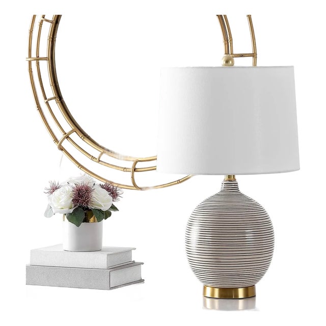 Illuminate your space with the sleek and functional KREMP table lamp. Standing at a convenient 23 inches, it is the...