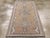 An antique Turkish Oushak accent rug. An open rose ground sets off two styles of Oushak medallions, each based on a...
