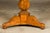 A French Empire period walnut table from the 19th century with circular marble top, pedestal and tripod base. Evoke the...