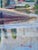 Mid-20th century oil painting in vibrant colors and brush strokes depicting a small Swedish village on a lake, with water...