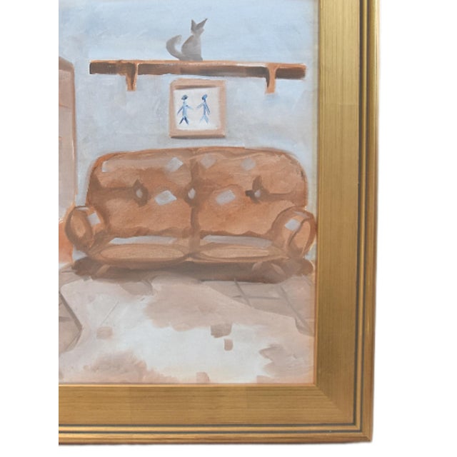 Original painting on stretched canvas in a gold frame depicting a cozy interior room with a brown sofa, a cat figurine on...