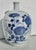Celadon body with an ink blue floral spray across the front and a pair of butterflies in flight on the back side. A...