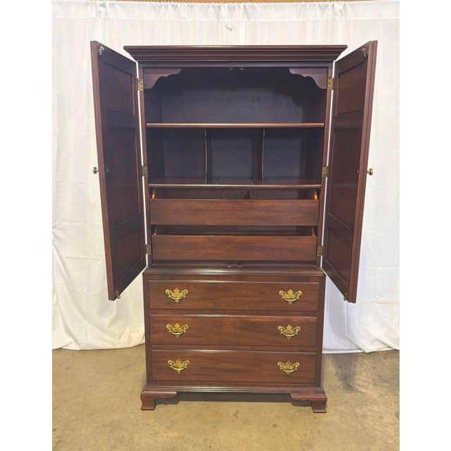 Hitchcock Solid Cherry Armoire. It has 2 shelves in the top with dividers and 2 Drawers. Three drawers on the bottom with...