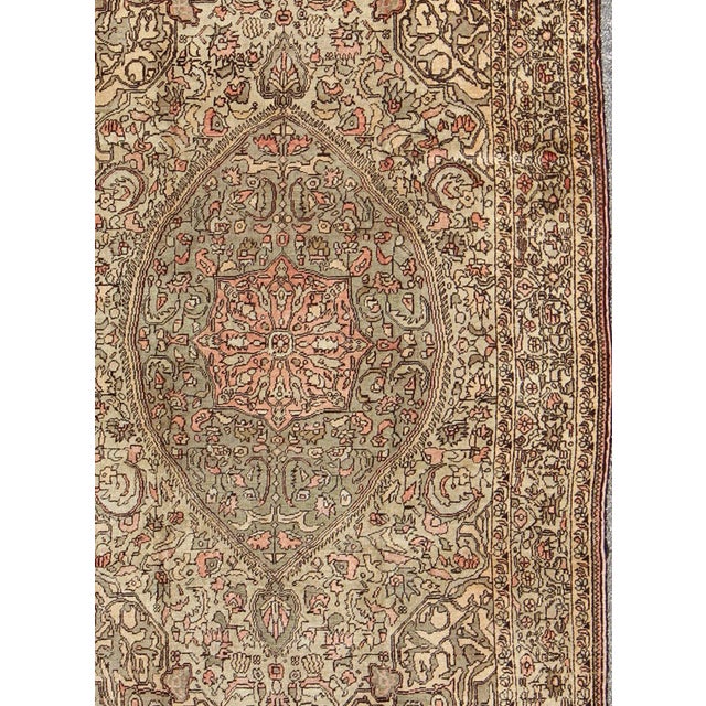 Measures: 5'6 x 9'11 This Turkish Sivas showcases a floral design utilizing botanical motifs spread through the central...