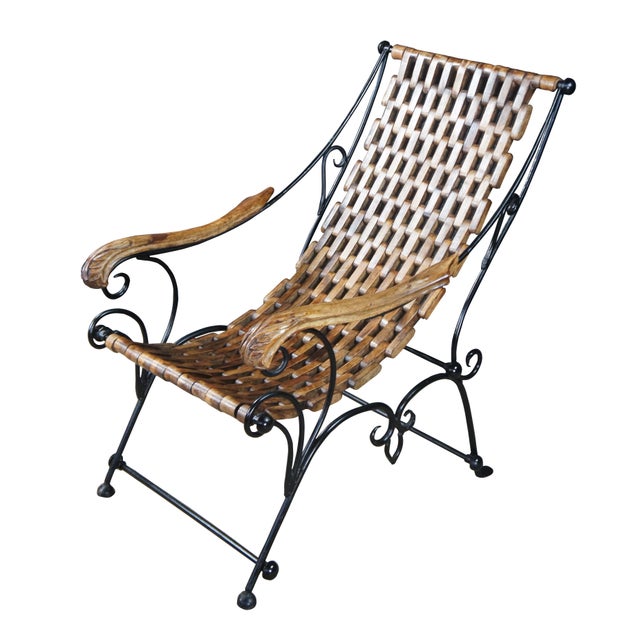 Vintage Middle Eastern saddle seat lounge chair. Made of scrolled wrought iron featuring a teak chain link style sling...