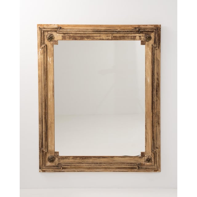 A 19th century French wall mirror in the Louis XVI style, featuring a structured frame with classical proportions and...