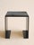This sculptural side table pairs a clean, architectural steel base with a solid marble top, creating a striking balance of...