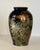 A mid 20th century dark blue vase decorated with a collection of stylized flowers in the Kutani style.