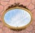 French Oval 1940s Wall Mirror With Gold Frame And Floral Decoration In Louis XVI Style For Sale - Image 3 of 8