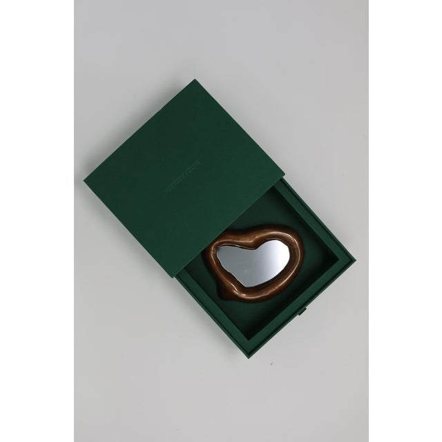 The Echoe Mini Mirror is a hand-sculpted, hand-cast, and hand-painted collectible design piece in resin and stone...