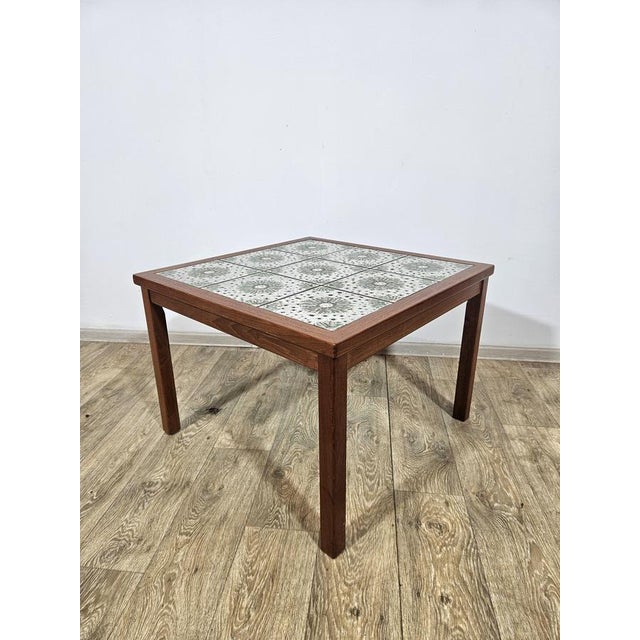 Teak coffee table lined with ceramic tiles. Produced in Denmark in the 1960s. It features authentic Mid Century Modern,...